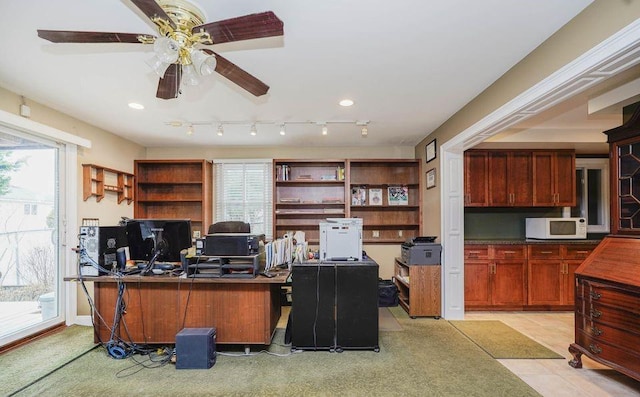 office with ceiling fan and light tile patterned floors