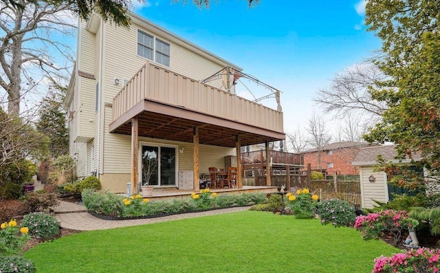 back of house with a yard and a deck