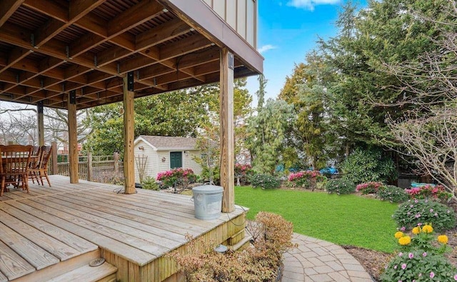 wooden terrace with a lawn and an outdoor structure