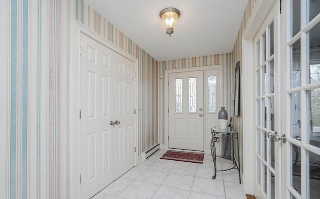 foyer entrance with wallpapered walls, light tile patterned flooring, baseboard heating, and french doors