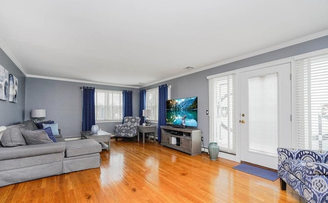 living area with light wood-style flooring and crown molding