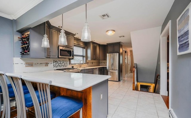 kitchen with light tile patterned floors, visible vents, appliances with stainless steel finishes, a sink, and a peninsula