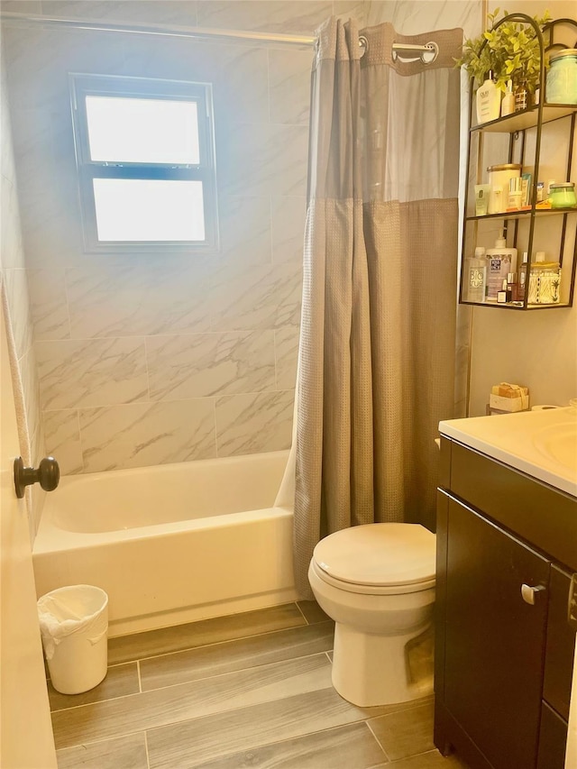 bathroom featuring wood finished floors, vanity, toilet, and shower / tub combo with curtain