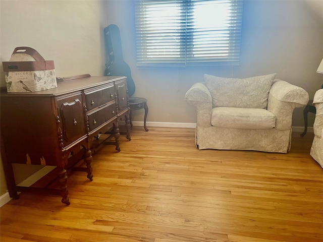 sitting room featuring light wood finished floors and baseboards