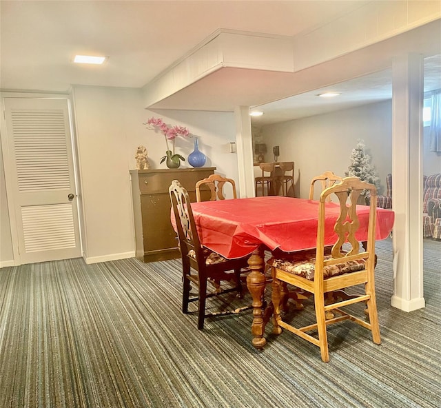 dining area featuring carpet floors and baseboards