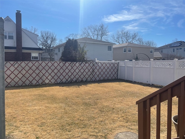 view of yard with a residential view and fence