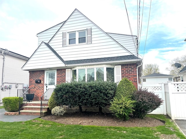 bungalow with fence and brick siding