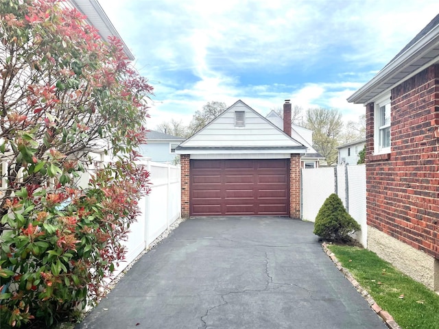 detached garage featuring fence