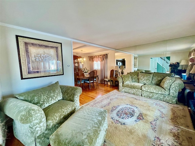 living area featuring a chandelier and wood finished floors