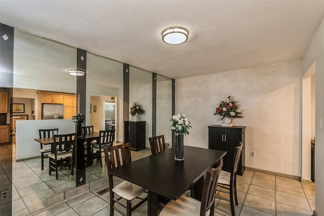 dining area with light tile patterned floors