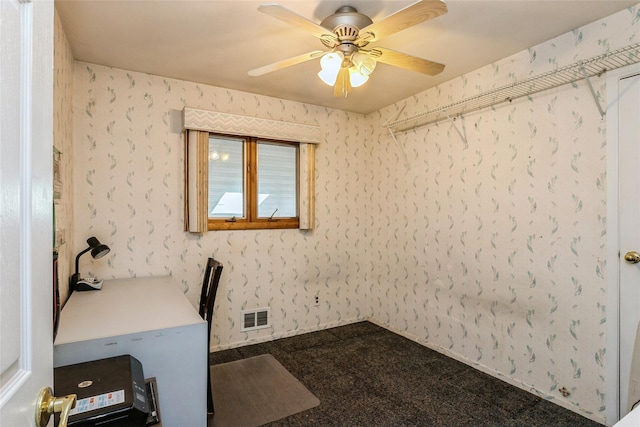 home office featuring visible vents, ceiling fan, and wallpapered walls