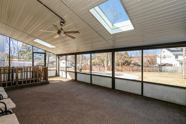 unfurnished sunroom with a wealth of natural light and ceiling fan