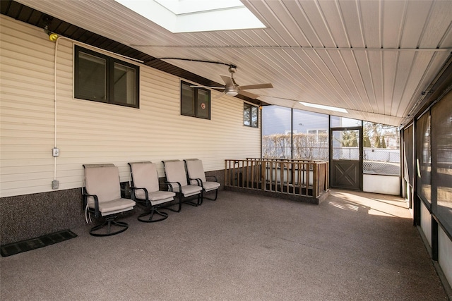 sunroom / solarium with a ceiling fan