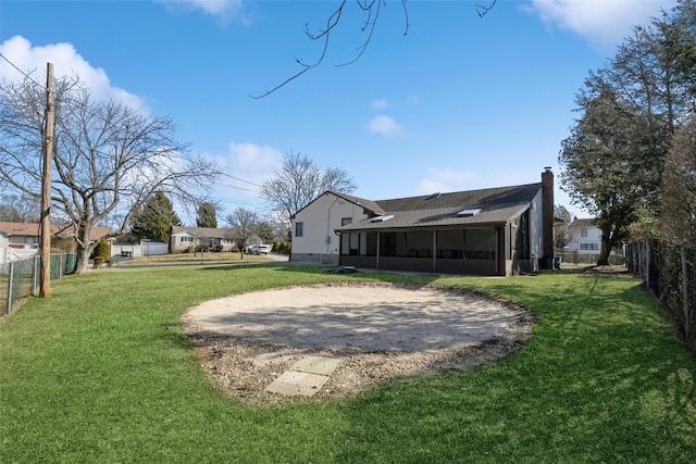 view of yard featuring a fenced backyard and a sunroom