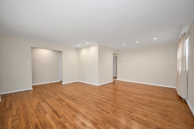 empty room with recessed lighting, baseboards, and light wood finished floors