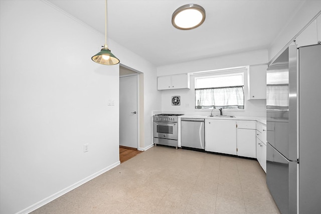 kitchen with appliances with stainless steel finishes, white cabinetry, light countertops, and baseboards