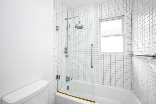 bathroom with enclosed tub / shower combo and toilet