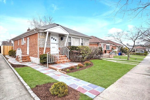 bungalow with stone siding, fence, a front yard, brick siding, and a chimney