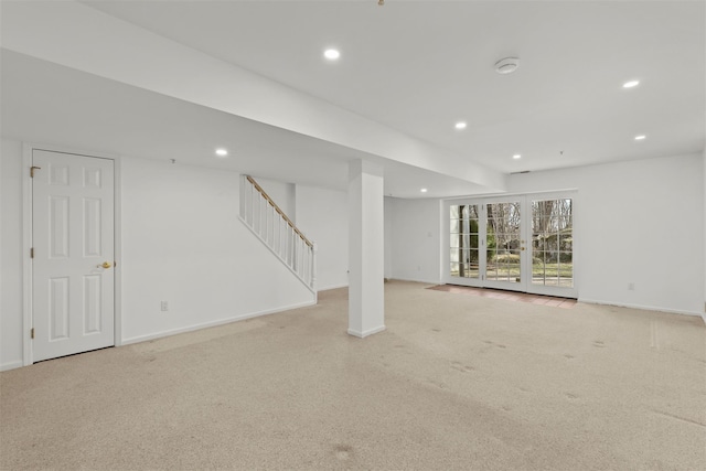 interior space featuring light carpet, recessed lighting, stairs, and baseboards