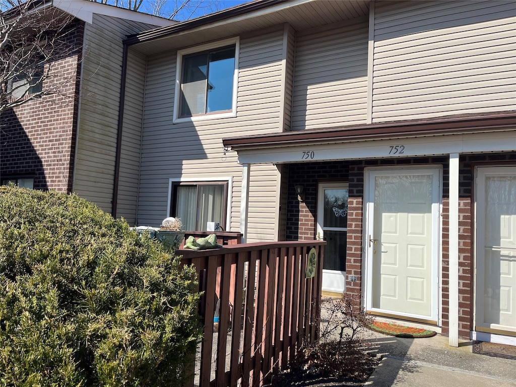 doorway to property with brick siding