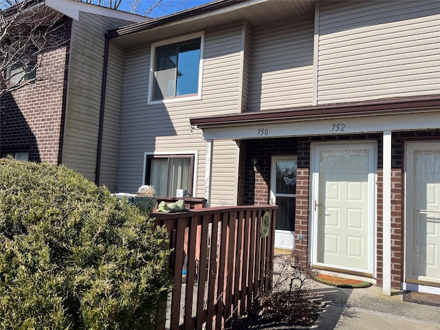 doorway to property with brick siding