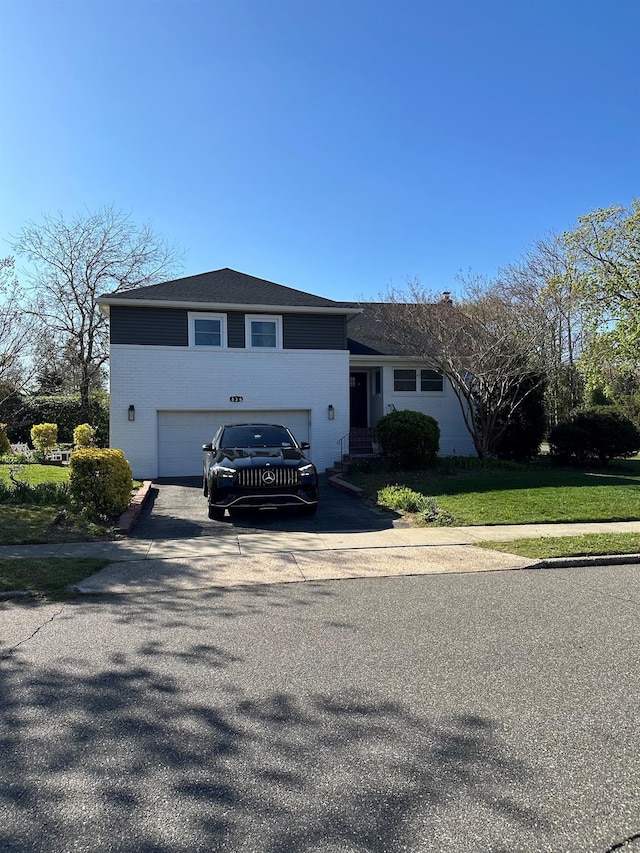 tri-level home with driveway and an attached garage