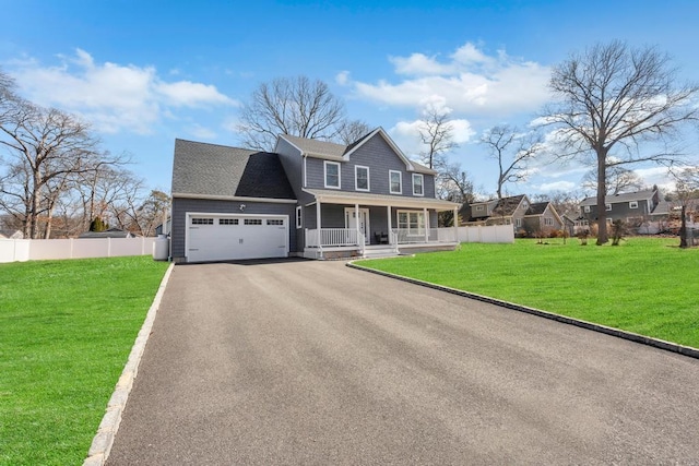 view of front of home featuring a front lawn, aphalt driveway, fence, covered porch, and an attached garage