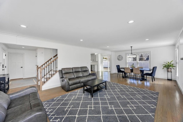 living room with ornamental molding, wood finished floors, recessed lighting, baseboards, and stairs