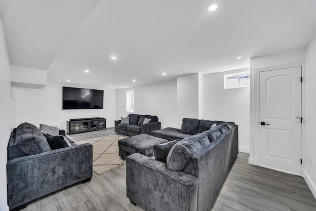 living room with recessed lighting, baseboards, and wood finished floors