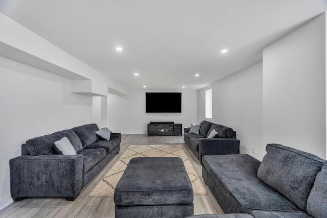 living area with recessed lighting and light wood finished floors