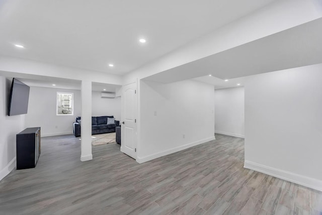 basement featuring recessed lighting, light wood-type flooring, and baseboards