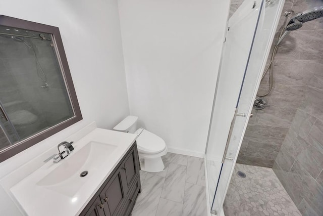 full bathroom featuring vanity, baseboards, a stall shower, toilet, and marble finish floor