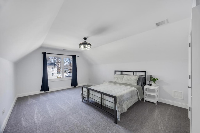 bedroom with visible vents, carpet flooring, and vaulted ceiling