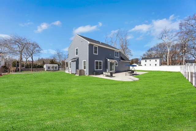 rear view of house featuring central AC, a patio area, a lawn, and a fenced backyard