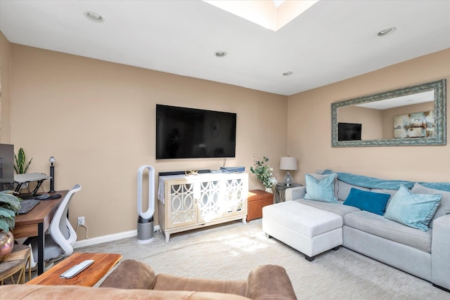 living area with a skylight, recessed lighting, and baseboards