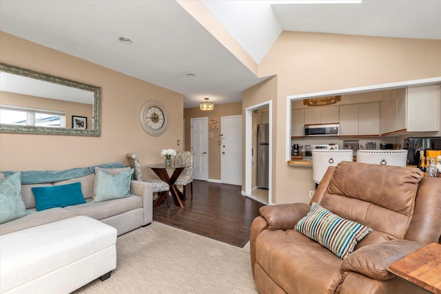 living area featuring lofted ceiling and wood finished floors