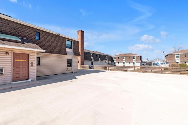 view of patio / terrace with a residential view and fence