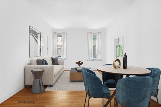 dining area featuring wood finished floors and baseboards