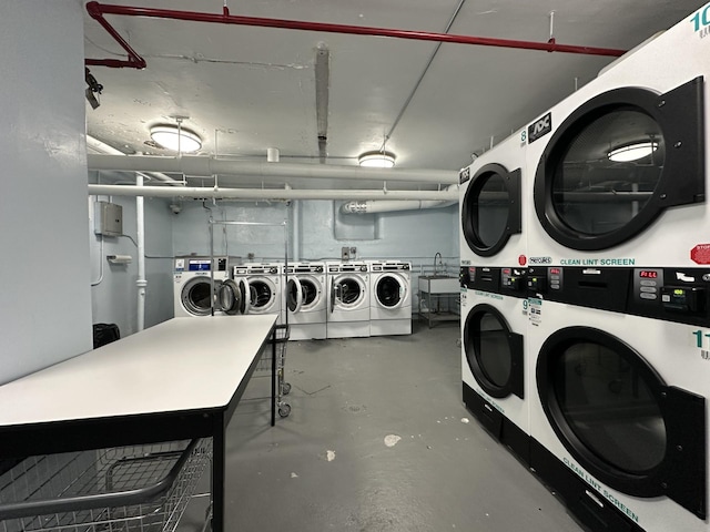 shared laundry area featuring washer and dryer, stacked washer and clothes dryer, and a sink