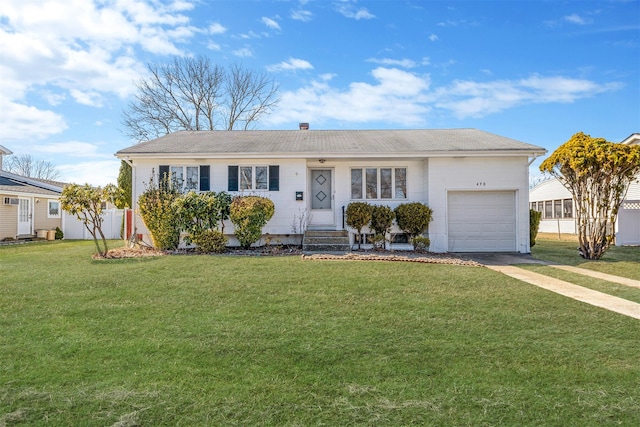 ranch-style house featuring a garage and a front lawn