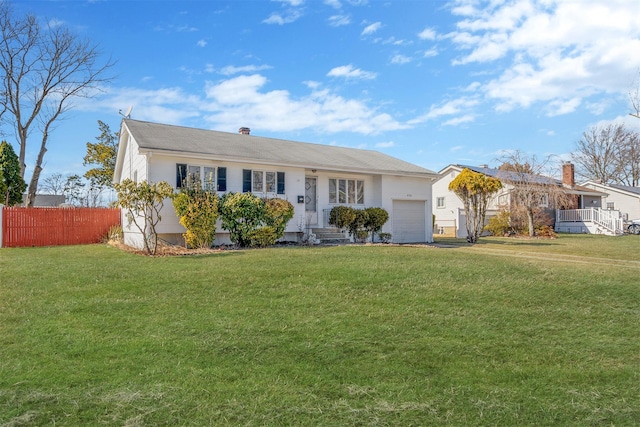 ranch-style house with a garage, a front yard, and fence