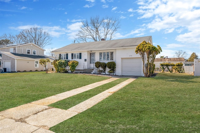 view of front of house featuring entry steps, an attached garage, driveway, a chimney, and a front yard