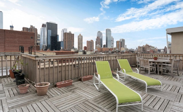 wooden terrace featuring a view of city