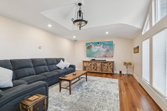 living room featuring hardwood / wood-style floors, recessed lighting, a baseboard radiator, baseboards, and vaulted ceiling