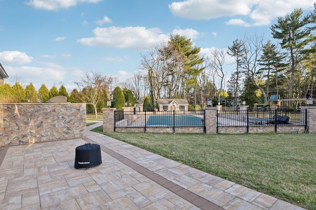 view of pool featuring a fenced in pool, a patio area, fence, and a lawn