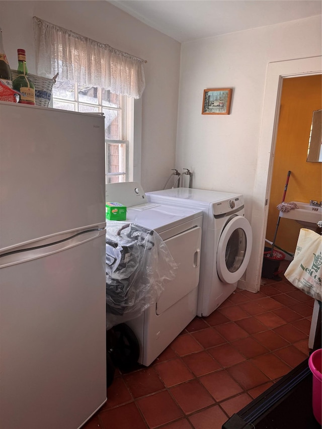 laundry room featuring washing machine and dryer, laundry area, and tile patterned flooring