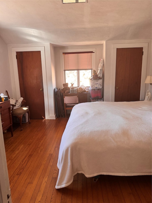 bedroom with hardwood / wood-style flooring