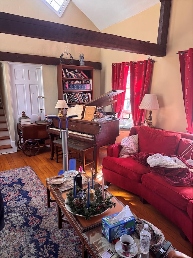 living room with stairway, wood-type flooring, and vaulted ceiling