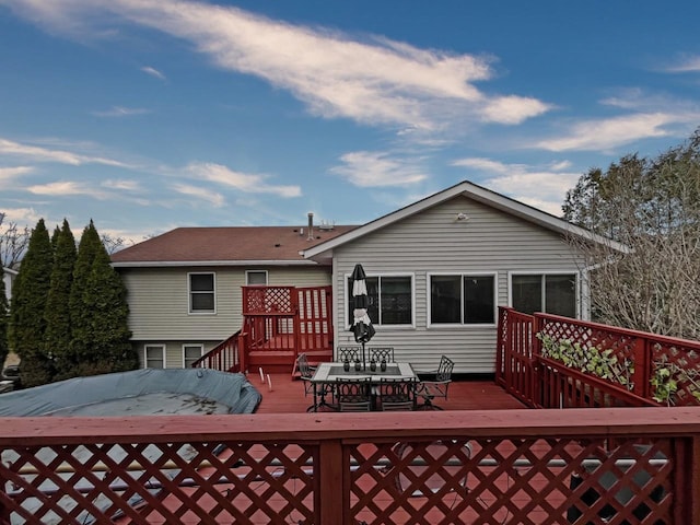 back of property featuring a deck