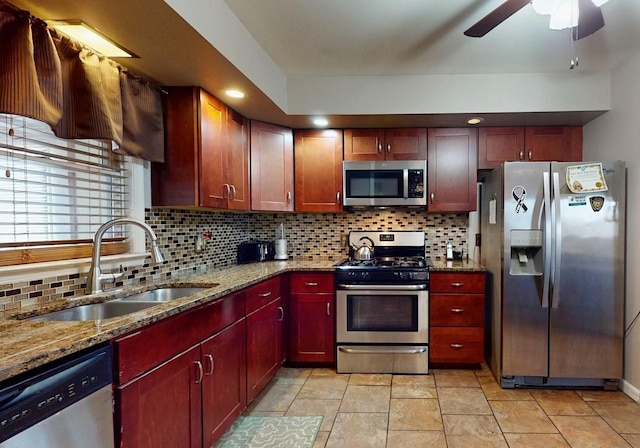 kitchen featuring decorative backsplash, dark brown cabinets, appliances with stainless steel finishes, and a sink